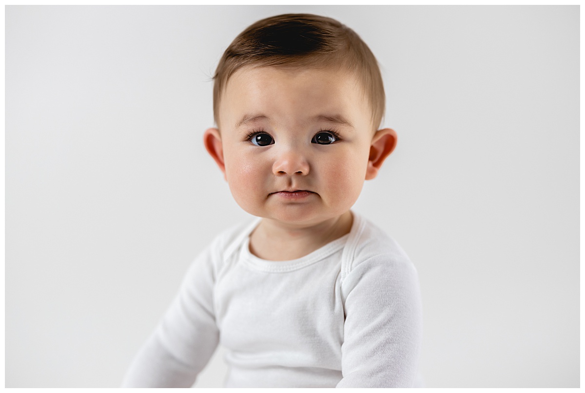 baby boy in white shirt at minimal sitter milestone session