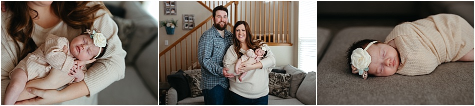 mom and dad hold newborn baby in living room