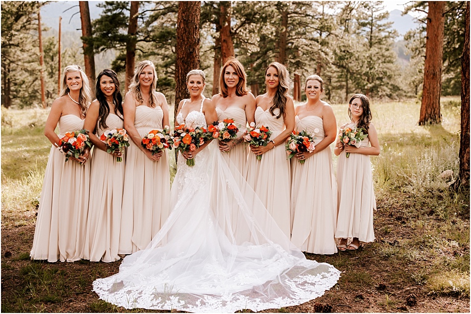 Bridesmaids standing in forest for mountain wedding in Estes Park, Colorado