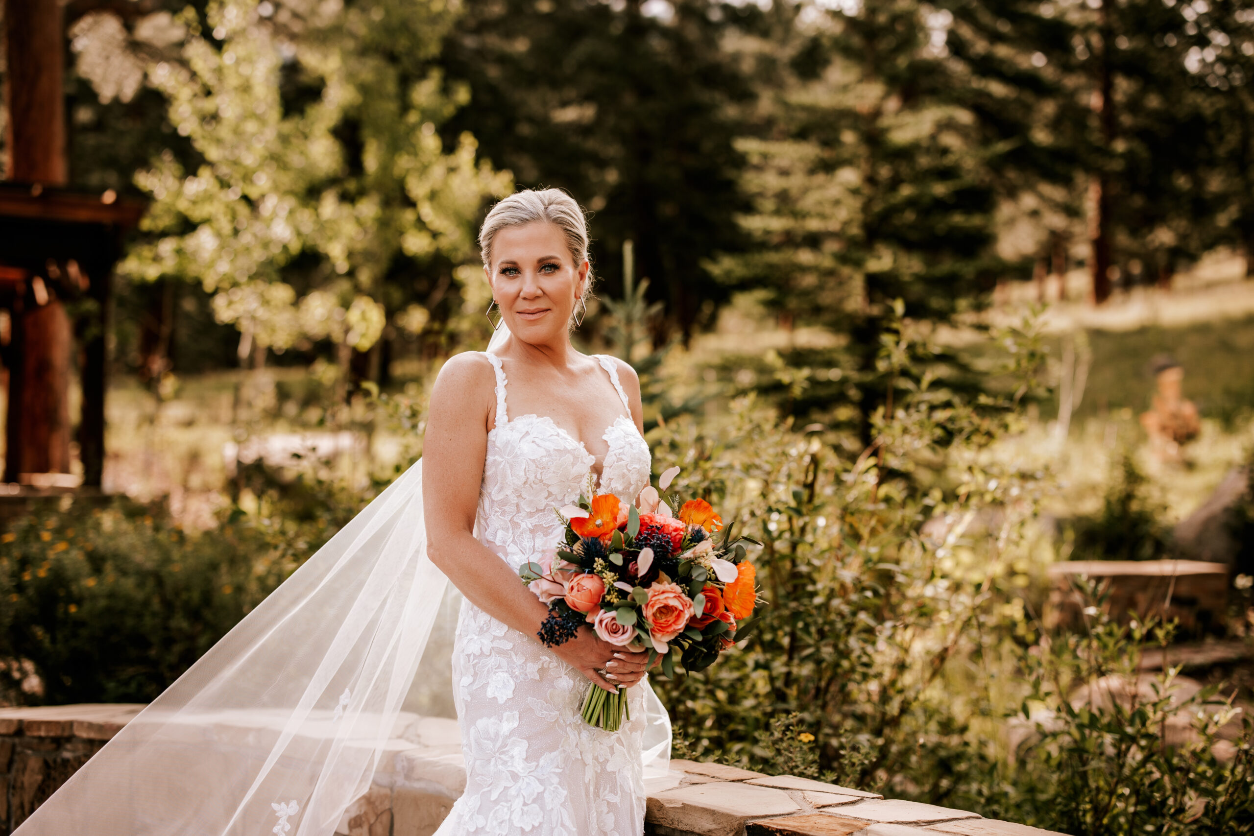 Bride poses with bouquet at Della Terra for a mountain wedding in Colorado