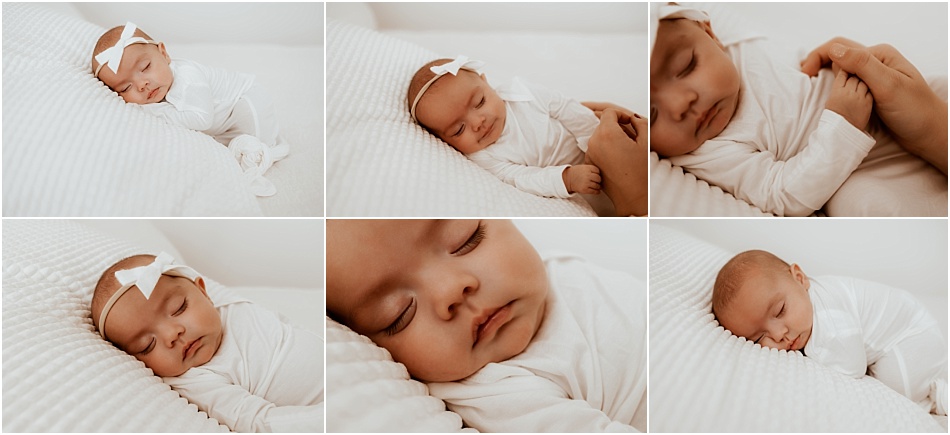 newborn baby girl in white outfit sleeps on white pillows and blankets at an indoor session