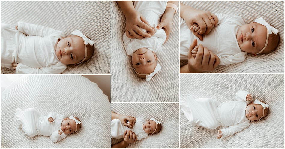 newborn baby girl in white outfit plays with mom on white pillows and blankets at an indoor session